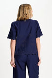 Dark blue blouse with palm tree pattern and a scalloped hem