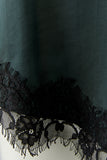 Forest green spaghetti strap camisole with black lace trim