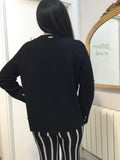 Black sweater with white pattern on cuffs
