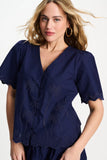 Dark blue blouse with palm tree pattern and a scalloped hem