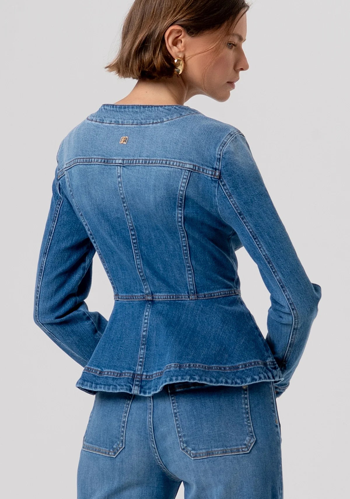 Denim jacket with peplum and gold buttons