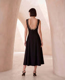 Sleeveless dress in black crêpe with chain detail.