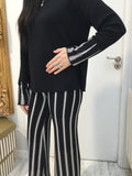 Black sweater with white pattern on cuffs