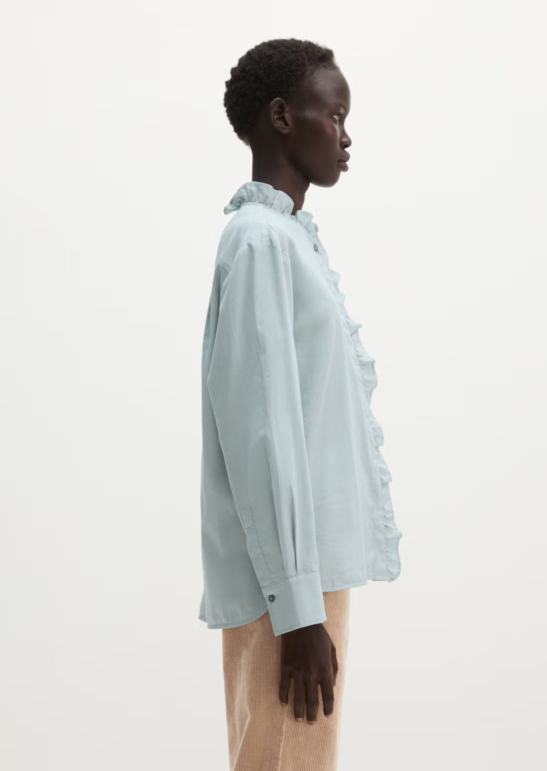 Long sleeve blouse in glacial blue with ruffle trim
