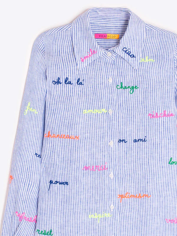 Light blue and white striped shirt with embroidered words