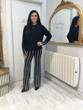 Black sweater with white pattern on cuffs