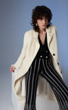Black knitted trousers with diamond pattern in white.