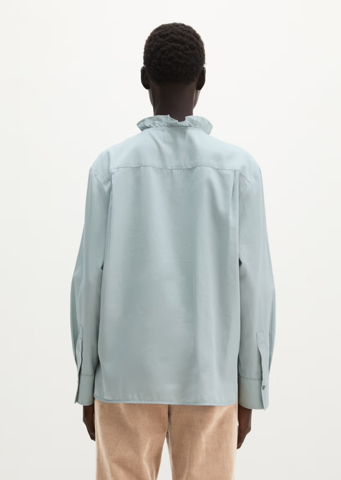 Long sleeve blouse in glacial blue with ruffle trim
