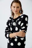 Black knitted hoodie with large polka dots in cream