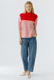 Red and cream Sweater with lip jacquard.