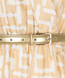 White and camel maxi dress in electric print with gold belt