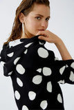 Black knitted hoodie with large polka dots in cream