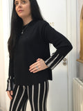 Black sweater with white pattern on cuffs
