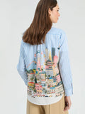 Vertically striped shirt in blue and white with panoramic illustration