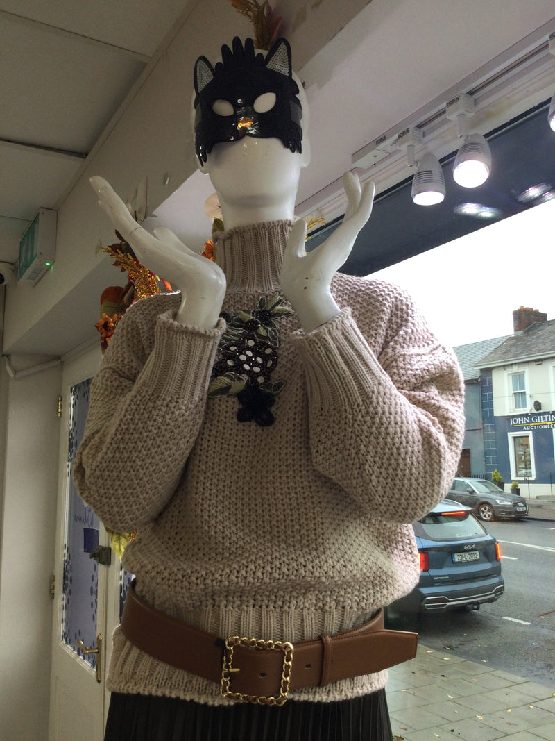 Beige sweater with beaded appliqué design