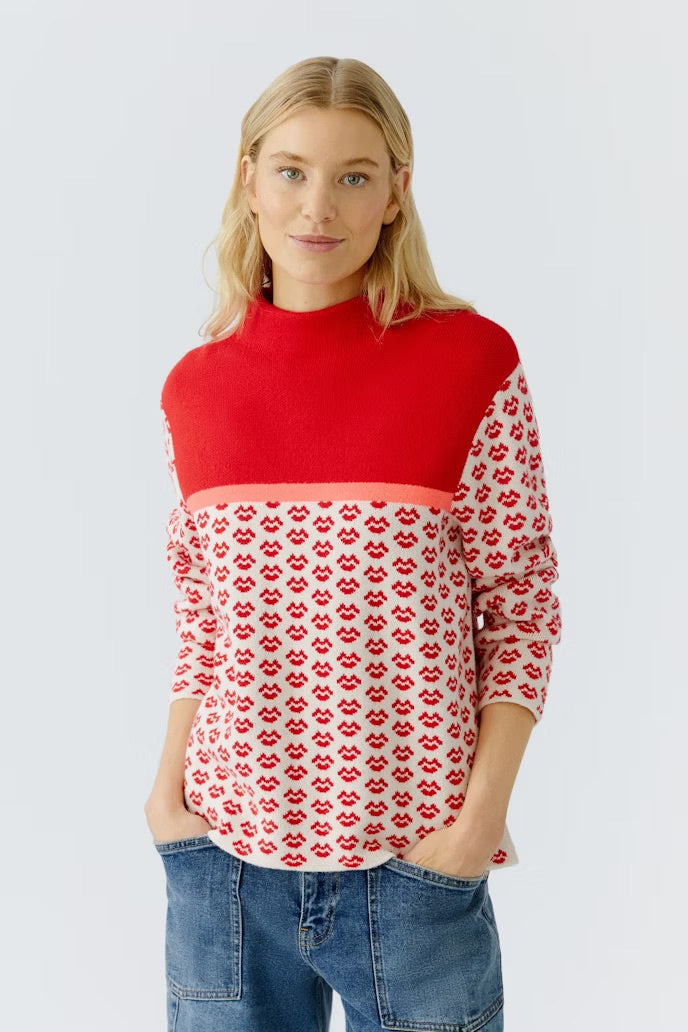 Red and cream Sweater with lip jacquard.