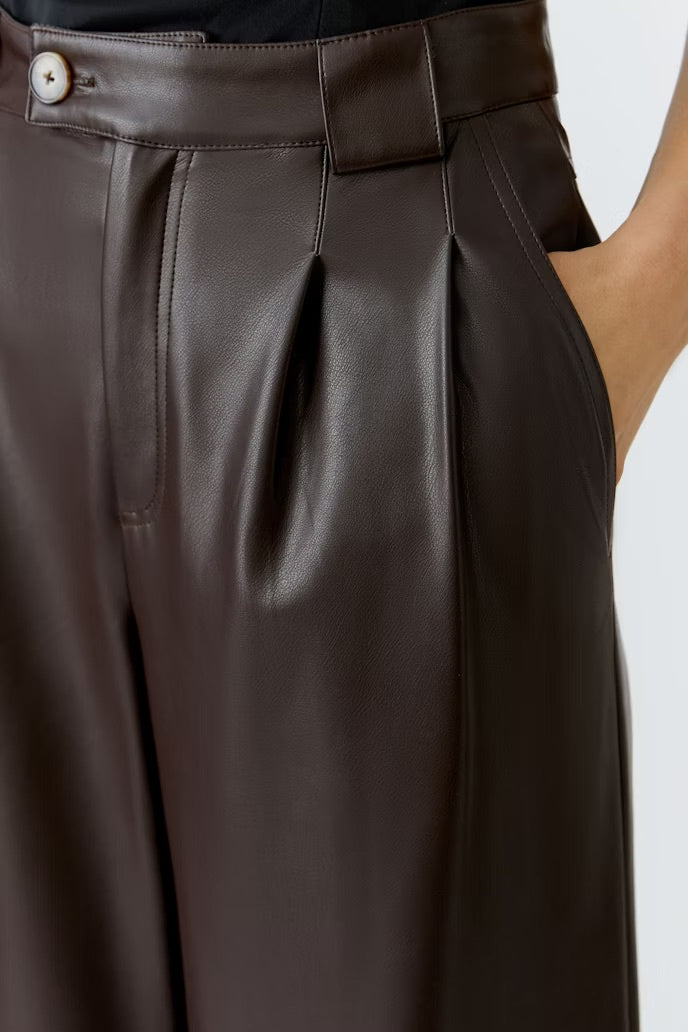 Wide pleated leather look trousers in chocolate brown