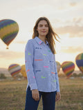 Light blue and white striped shirt with embroidered words