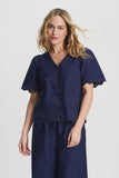 Dark blue blouse with palm tree pattern and a scalloped hem