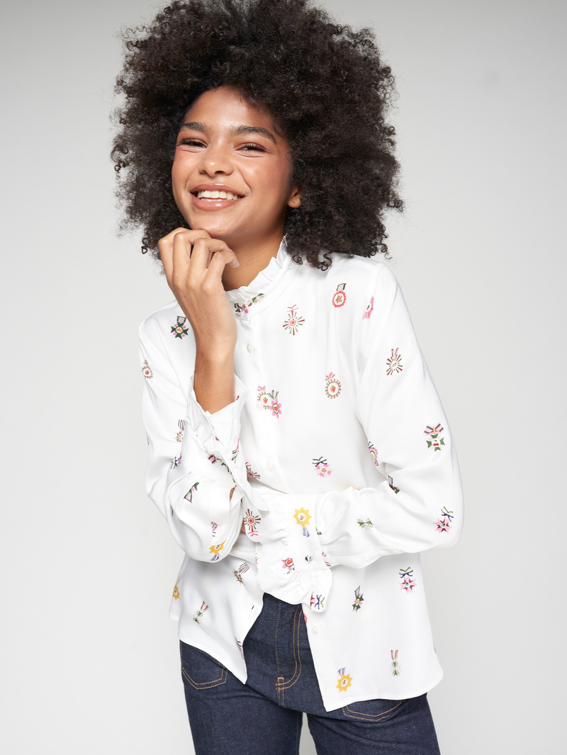 Off white shirt with colourful rosettes and high ruffled collar