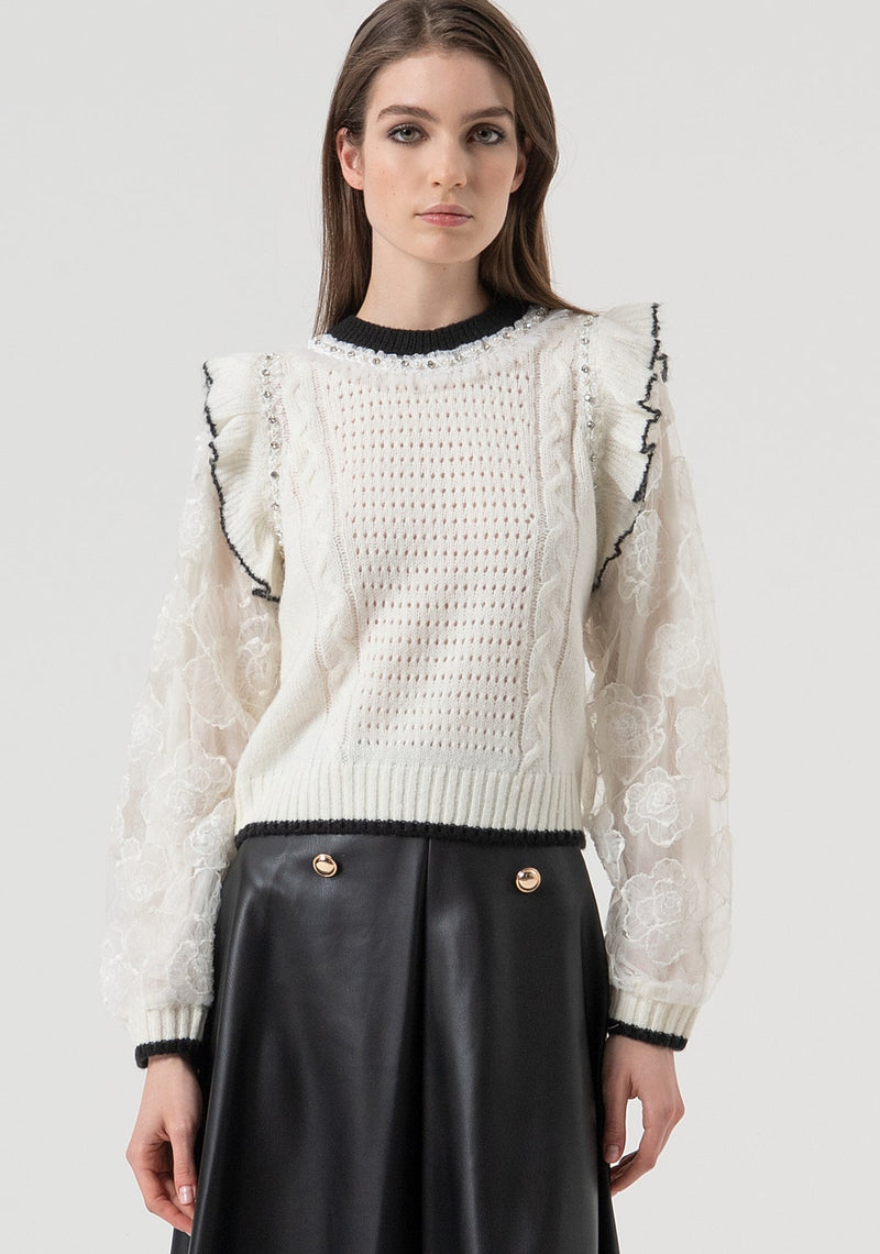 Round neck sweater in cream with black trim and lace sleeves.