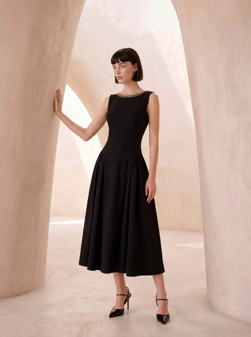 Sleeveless dress in black crêpe with chain detail.