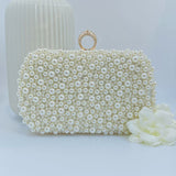 Pearl clutch with gold ring trim