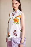White blouse with floral pattern and lace hemline